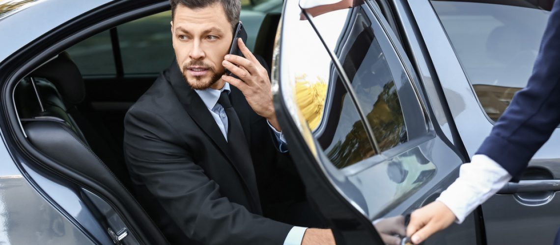 Businessman,Getting,Out,Of,Luxury,Car